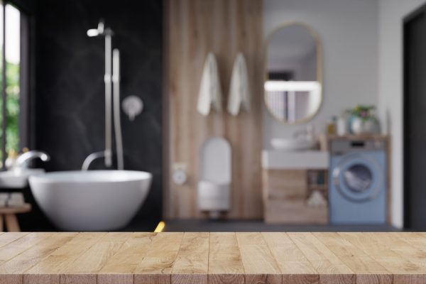 Wood table top on blur bathroom,Empty tabletop for product display with blurred bathroom,3d rendering